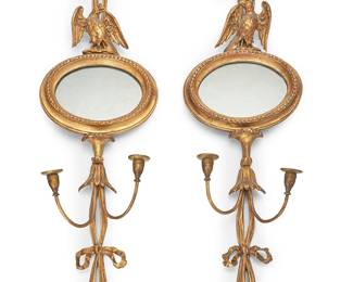 1141
A pair of Regency style giltwood girandoles
20th century
Each with central mirror crested by an eagle, flanked by ribbons issuing two candle nozzles
2 pieces
Each: 46.5" H x 12.25" W x 5.5" D
Estimate: $400 - $600