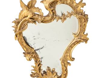1238
A French Rococo style giltwood mirror
In the manner of Gabriel Viardot (1830-1906), late 19th/early 20th century
The asymmetrical frame with acanthus leaves, rocaille, floral elements, and a dragon in relief
49" H x 33" W x 4.75" D
Estimate: $2,000 - $3,000