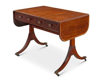 1139
A Regency mahogany sofa table
Early 19th century
One side with two locking drawers, the other with false fronts, flanked by swingarm drop leaves, raised on brass paw feet and casters
27.25" H x 35.5" W x 25" D; Open: 54.25" W
Estimate: $400 - $600