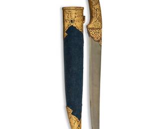 1126
An Indo-Persian ceremonial knife and other knives
17-19th century
From the Qajar Dynasty (1789-1925), with gilt-metal animal-form hilt with inset glass eyes, housed in a gilt-metal-mounted felt-lined wood sheath (sheathed: 15.375" L, unsheathed: 14.25" L, blade 10" L)
Together with two daggers with mother-of-pearl handles (larger sheathed: 17.5" L, unsheathed: 14.5" L, blade 10" L; shorter sheathed: 13" L, unsheathed: 10.5" L, blade 5.625" L), a dagger with inlaid silver accents (17.625" L, blade 11.5" L), and a small dagger with gilt highlights to blade (12.25" L, blade 8" L)
5 pieces
Estimate: $600 - $800