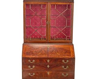 1168
A George III mahogany secretary bookcase
Late 18th/early 19th century
The upper console with openwork broken pediment with denticulated trim above an astragal glazed cabinet with later upholstered and illuminated interior and two glass shelves, the lower console with drop front opening to reveal a fitted interior, above four locking drawers, raised on ogee bracket feet, electrified
Upper console: 50" H x 45" W x 14.5" D: Lower: 43.5" H x 45" W x 21.5" D
Estimate: $3,000 - $5,000