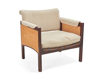 1320
A Modern caned lounge chair
In the manner of Edward Wormley (1907-1995)
Late 20th century
Unmarked
The wood chair with leather strapping to seat and fabric upholstered seat cushion, seatback, and armrests, featuring caned accent panels to each side
30.5" H x 20.5" W x 31" D
Estimate: $250 - $350