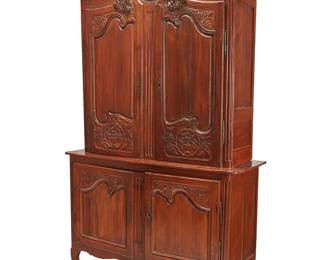 1330
A Louis XV Provincial buffet a deux corps
18th/19th century
The upper unit with locking hinged cabinet doors surmounted by an architectural scroll cornice, opening to reveal two shelves and the interior later lined with fabric upholstery, the lower unit with locking hinged doors revealing a single shelf, all raised on front scroll and rear square feet
Lower: 39" H x 58.5" W x 21" D; Upper: 57.25" H x 55" W x 18" D; Overall: 96.25" H
Estimate: $400 - $600