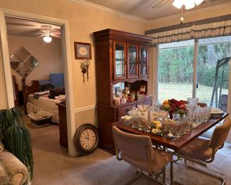 China hutch, dining room table and four chairs, candles, candles, and more candles - small and large, clock.