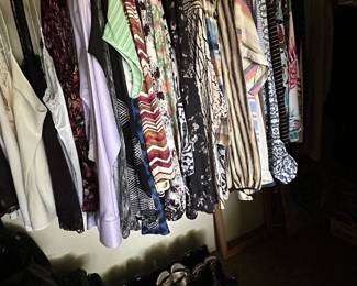 Closets filled with ladies clothing, shoes and accessories. 
