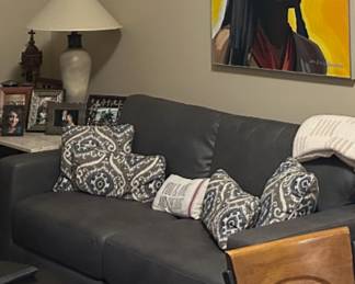 Brand new couch and gray with a queen size bed in it