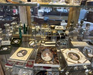 Sterling table ware, enamel boxes, mother of pearl etui, silver busts of laughing boy and crying boy, French frames, dresser bottles and ivory handled paper knife and magnifying glass. 