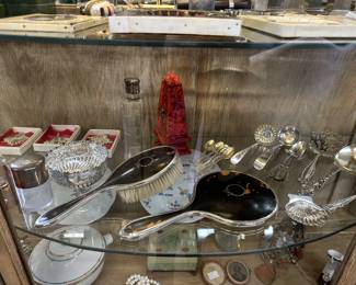Sterling silver ornaments, table ware, dresser sets and perfume bottles. 