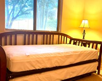 A trundle bed is a space-saving, low-profile bed with wheels that slides under a primary twin/single bed, 