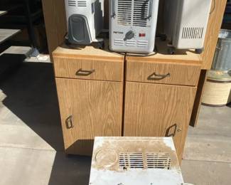 Three Portable Heaters And A Window AC
