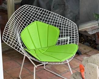Knoll Bertoia Diamond lounge chair with a green seat cushion