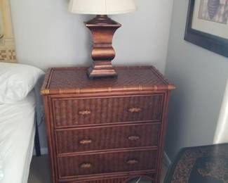 Woven wicker nightstand; table lamp