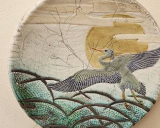 Pottery Art hangs on the wall. 