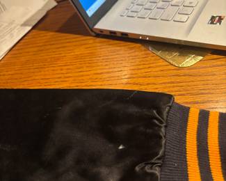 THE ONLY THING IS A WHITE DOT ON THE BACK OF THE RIGHT SLEVE.  IT IS SMALLER THAN A PENCIL ERASER.  IT POSSIBLY IS A DROP OF PAINT.  