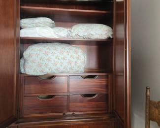 Bedding in an armoire by Ethan Allen