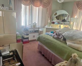 1980’s white lacquer Bedroom Set with iconic shell mirrored headboard, in queen size, two matching end tables, a dresser with mirror and a petite sized armoire. Priced to sell. Available for pre-sale.