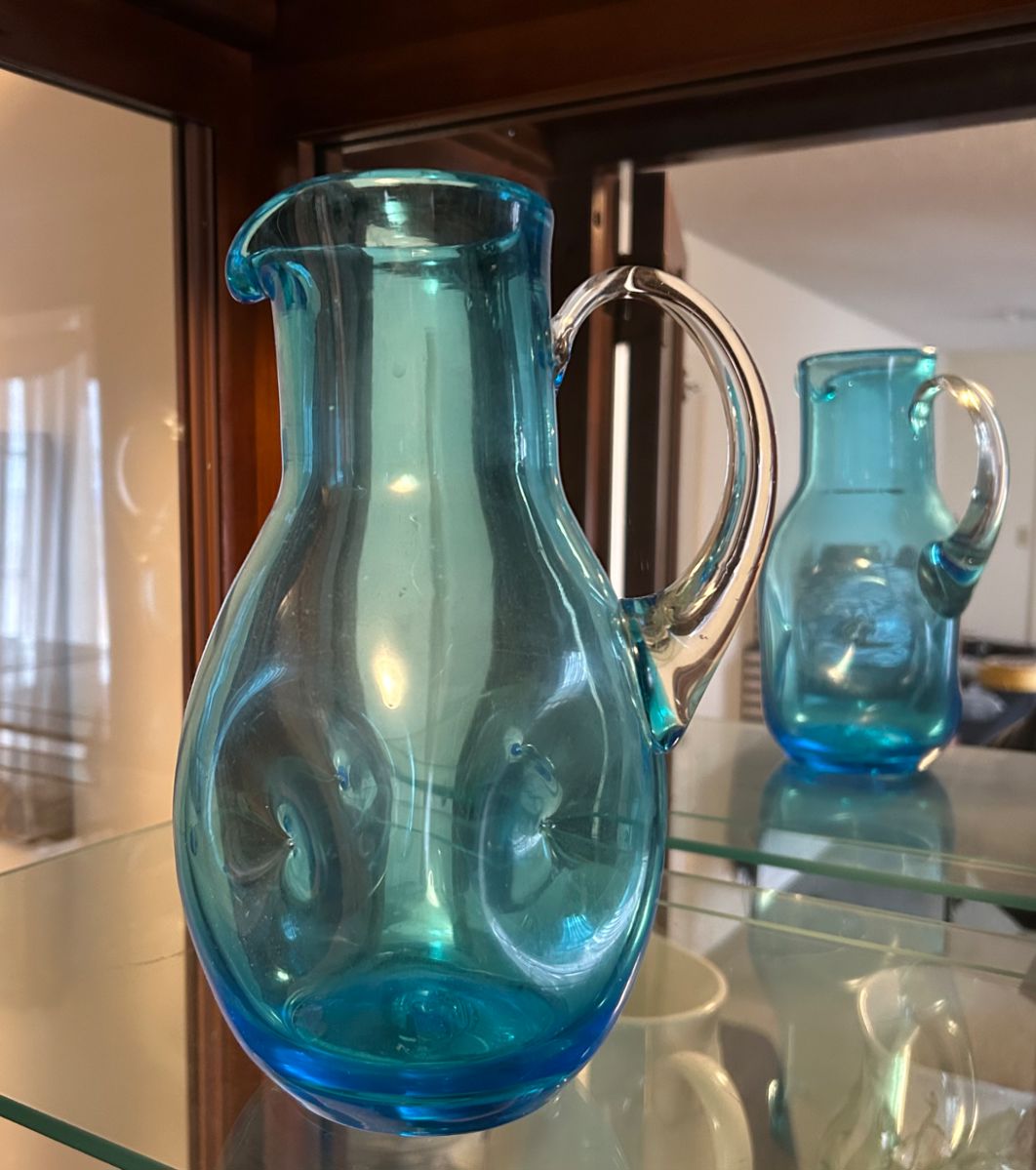 Vintage hand-blown art glass pitcher in a turquoise color.