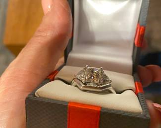 Certified by the American geological Institute certification papers on hand center stone is flawless 2 carat princess cut surrounded by 21 carat diamond cut stones set in platinum