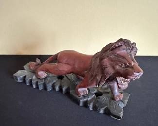 Hand carved wooden lion on wooden base