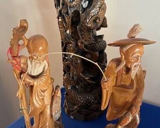 Hand-carved wood figurines and totem-style carving depicting various sea life.