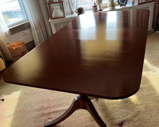 Georgian or Regency style mahogany double pedestal extension dining table with protective felt pads. In excellent condition. 75x 43 with one 12 inch leaf. Brass capped feet.