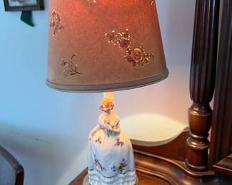 pair of antique porcelain lamps in excellent condition with original flower die cut shades. women