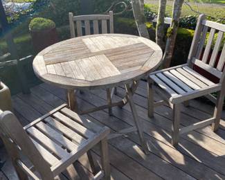 $160. Teak table and three chairs.  Table has an as found issue in next photo.  Table is 35" diameter x 31.5"h.  