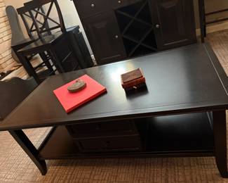 $180. Wood coffee table with 2 storage drawers.  47.5 inches wide by 24 inches deep by 18 inches high.