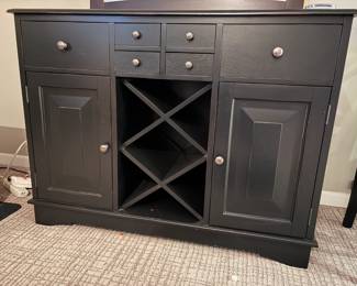 $380 Bar cabinet with bottle and glass storage racks as well as 6 drawers and two doors hiding glass racks and shelves.