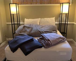 Bedding and blankets for sale during in person shopping. Details on the bed and the lamps in the next photos.