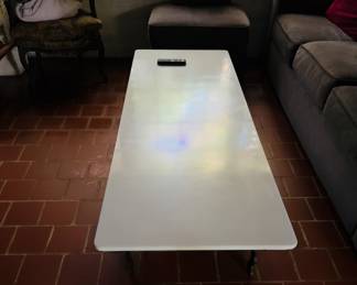 Milk glass (?) coffee table with iron legs.