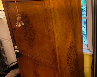 Beautiful antique wooden armoire with intricate designs. Marble top.