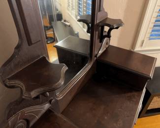 Elegant antique wooden dresser with ornate mirror and drawers. 