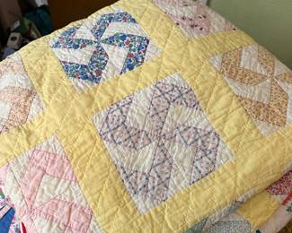 Vintage patchwork quilt featuring a cheerful yellow and white grid with "diamond-in-a-square