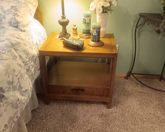 2 nightstands with narrow drawer on the bottom.