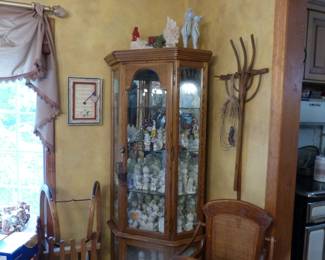 Curio cabinet with Precious Moments collection, antique wooden pitchfork