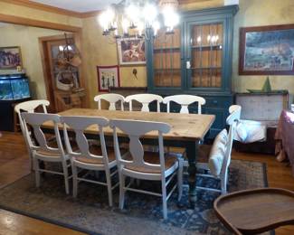 Rustic farmhouse dining table with 8 chairs, painted green breakfront antique trunks, 