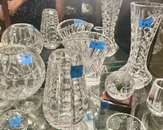 Waterford Crystal: Vases - round $30; oval $35; tall narrow center $75; cone cylinder shape $40;
Round Paperweight on wood pedestal $30; Orrifers small vase $10