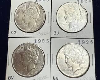 US Peace Silver Dollars from the years 1923, 1924, 1925, and 1926.