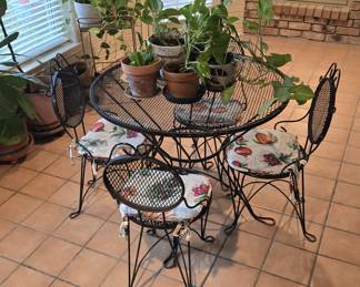 Vintage Black Wrought Iron Mesh Scroll Patio Set with a Round Table and Four Chairs
