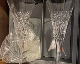 Waterford (in box) toasting champagne flutes.  retail $275.  We have 5 sets. each set is 75 dollars.  Great wedding/shower gift