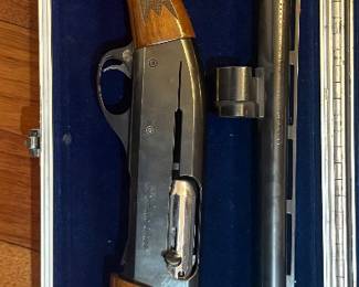 This is a Remington Model 11-87 Premier Trap shotgun, chambered for 12 gauge, 2 3/4 inch shells. The shotgun features a walnut stock and forend with a checkered pattern for grip. The receiver is engraved with 'Remington Model 11-87' and 'Premier Trap'. The barrel is ported, indicating it is designed for trap shooting to help reduce recoil and muzzle jump. The overall condition appears to be good, with normal handling marks consistent with use.