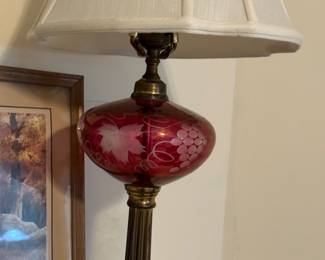 One of a pair of vintage cranberry glass and brass lamps