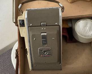 Vintage Polaroid camera complete with flash and case