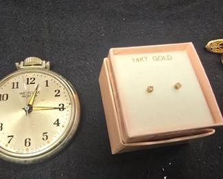 gold earrings and a pocket watch 