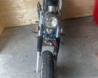 chrome fenders, black vinyl saddle, and off-road tires