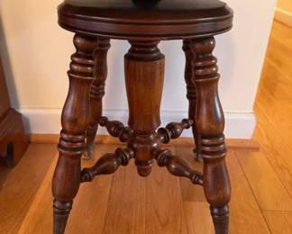 Antique swivel piano stool with metal and glass claw feet