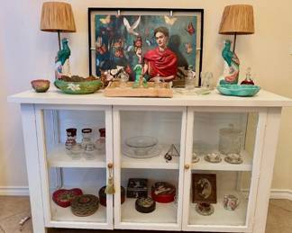 White cabinet, stunning peacock lamps, pottery, crystal and antique tins