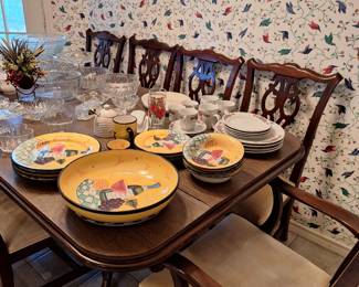 Beautiful dishes and dining table with a leaf and eight chairs