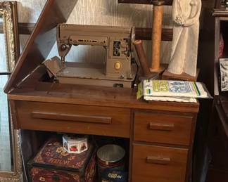 vintage Singer 301 or 301A sewing machine in a dedicated wooden cabinet. 